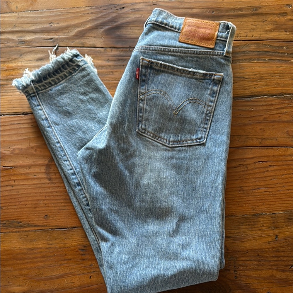 501 Levi's Classic Light Blue Jeans with fringe bottom.